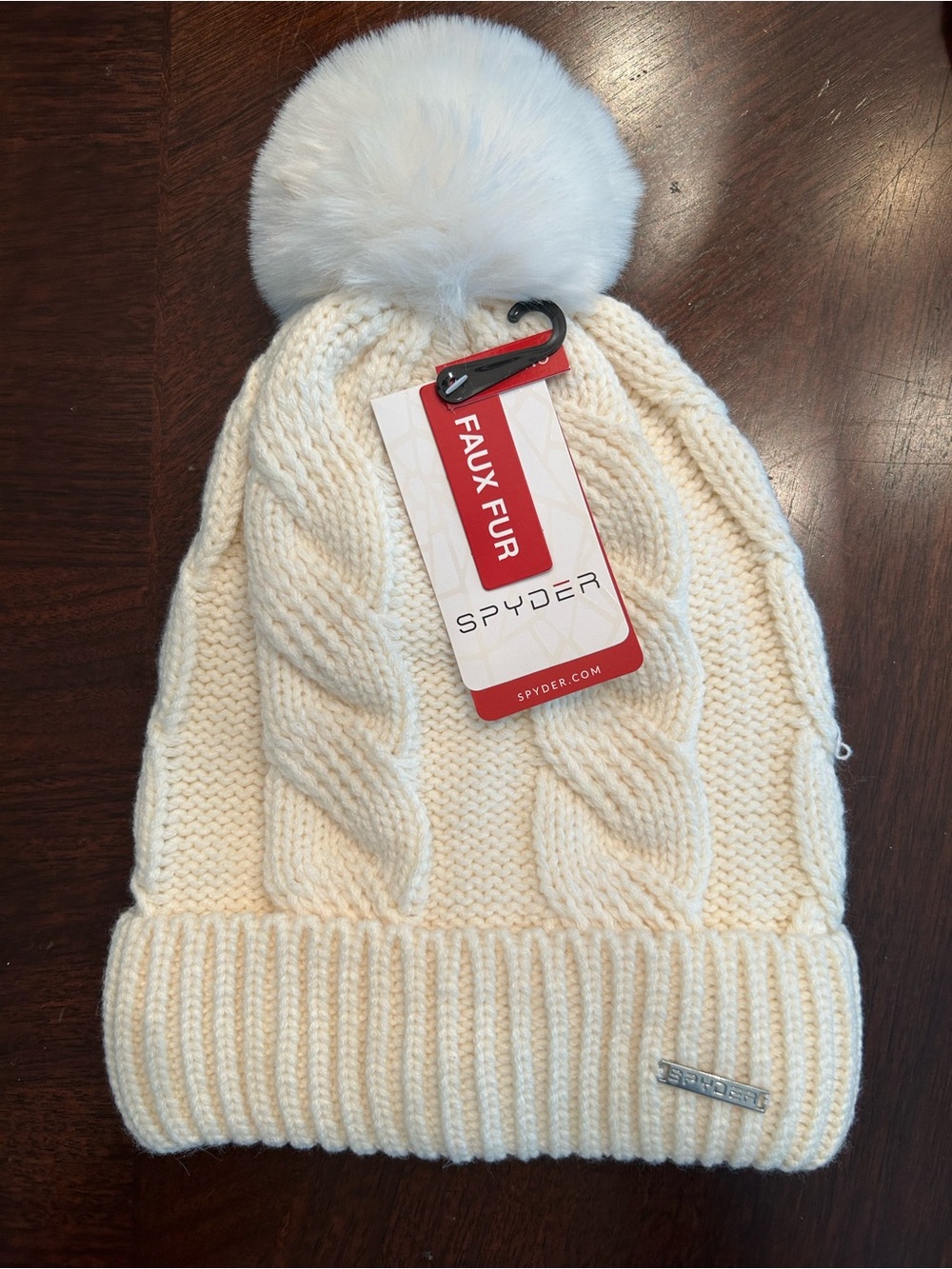 Spyder Cream Cable Knit Beanie with Faux Fur Pom and liner.